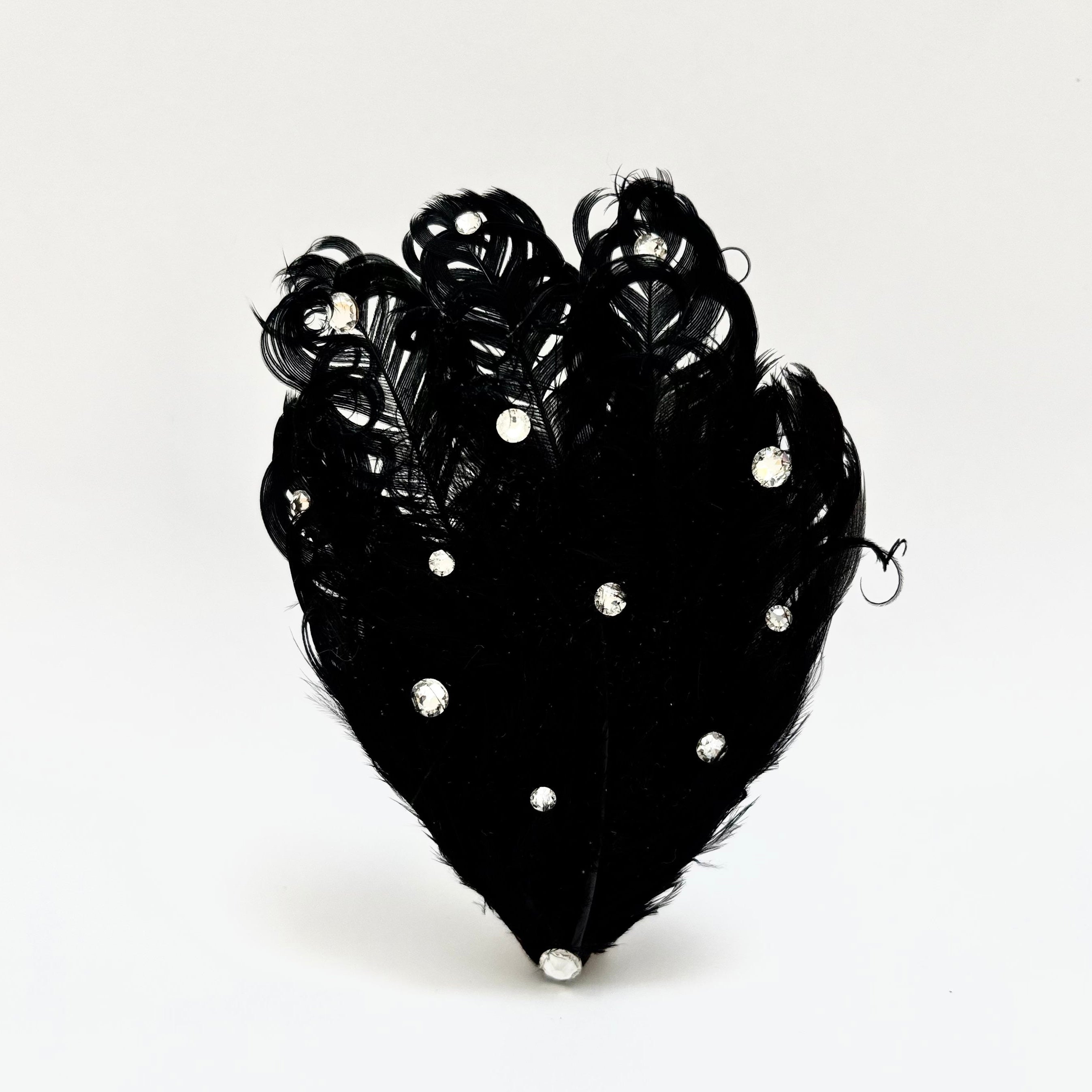 Handmade black feather hair clip with softly curled detailing and clear crystal highlights, suited for polished evening hairstyles by Nicole Ho.