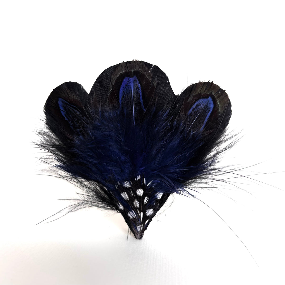 Handmade navy blue feather hair clip and brooch with a natural pattern of vivid blue and black, fluffy texture and black and white spotted feather detail by Nicole Ho.