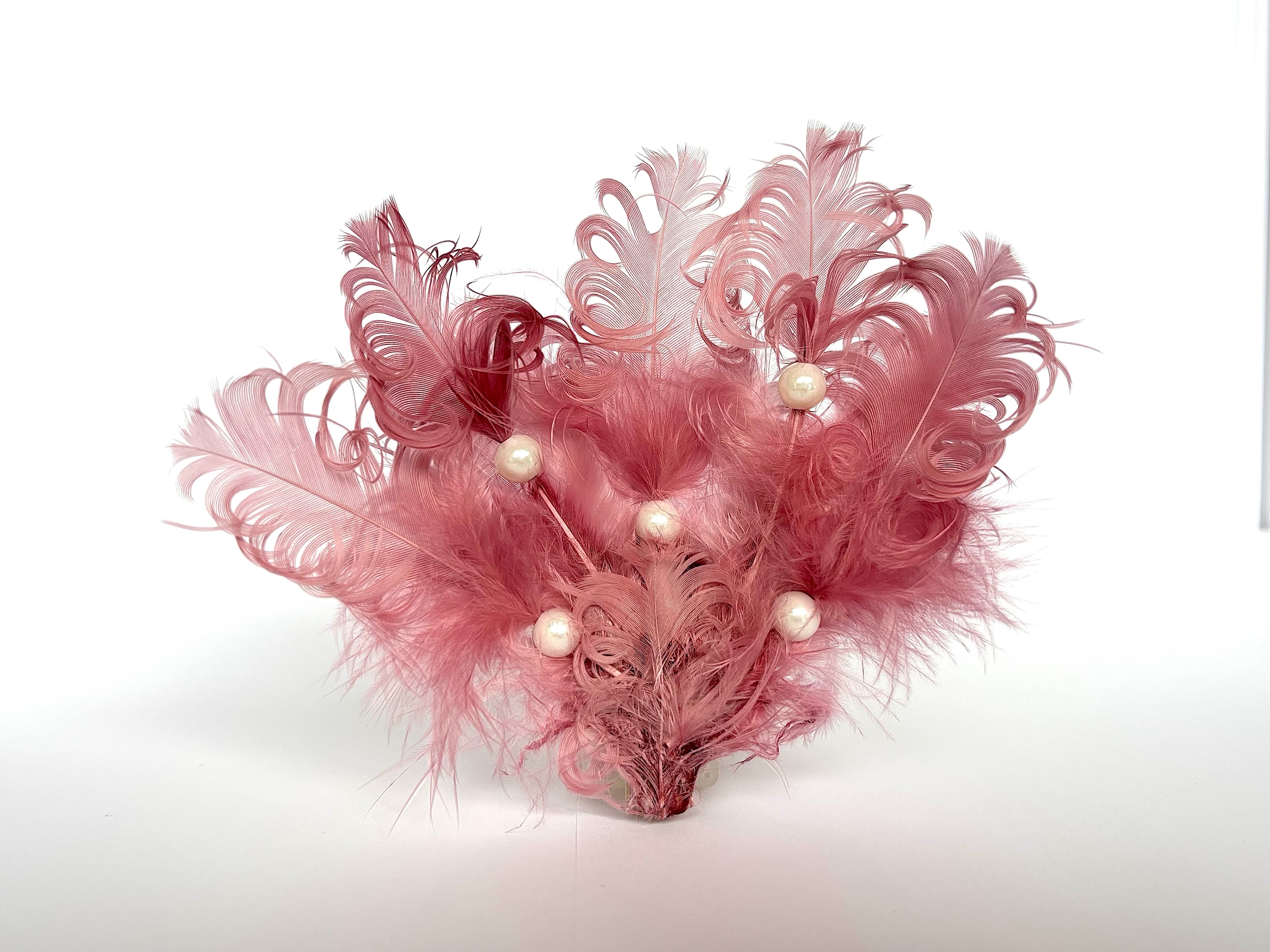 Handmade pink feather hair clip with pearl accent, feather hair accessory by Nicole Ho London.