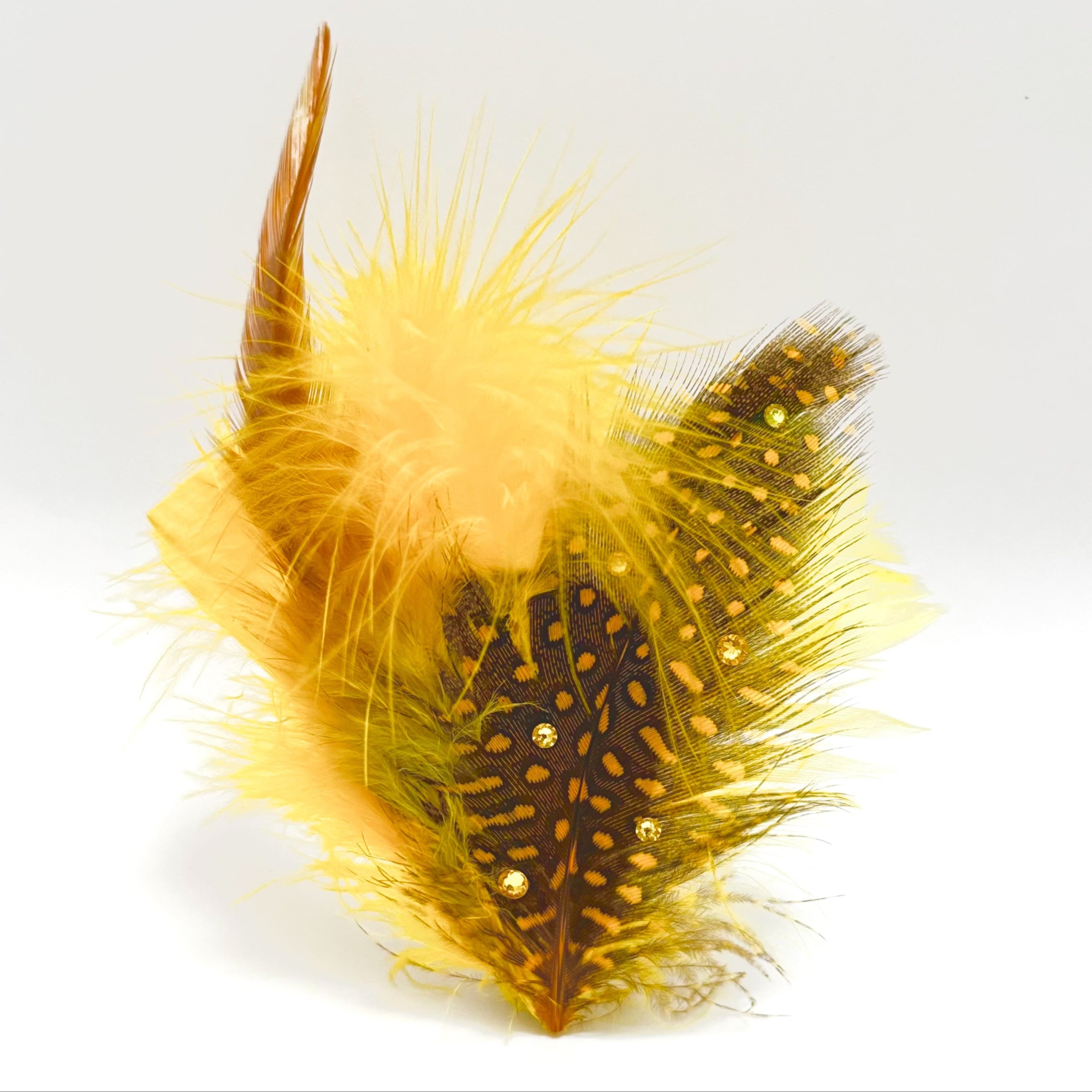 Handmade yellow and brown feather hair clip with bright fluffy texture, patterned feather detail, and subtle crystal radiance for expressive styling by Nicole Ho.